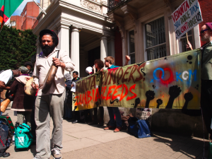 Protesters in London hold a banner saying 'Vedanta plunders, Zambia bleeds'