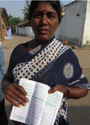 Local woman at Mettur holds her medical records to show how pollution is affecting them