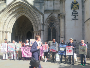 man walks past rally outside the Royal Courts of Justice on 5th July